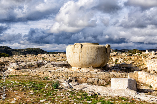Massive stone vase in Amathus ruins, Cyprus under stormy clouds photo