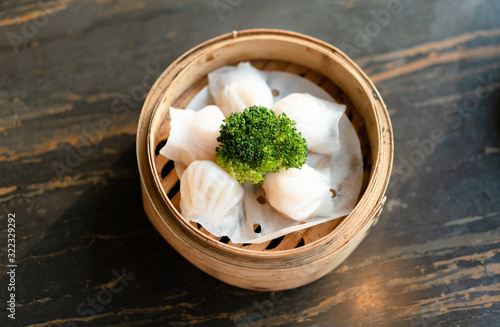 tradition Chinese prawn dumplings (hagao) placed in a bamboo steamer photo