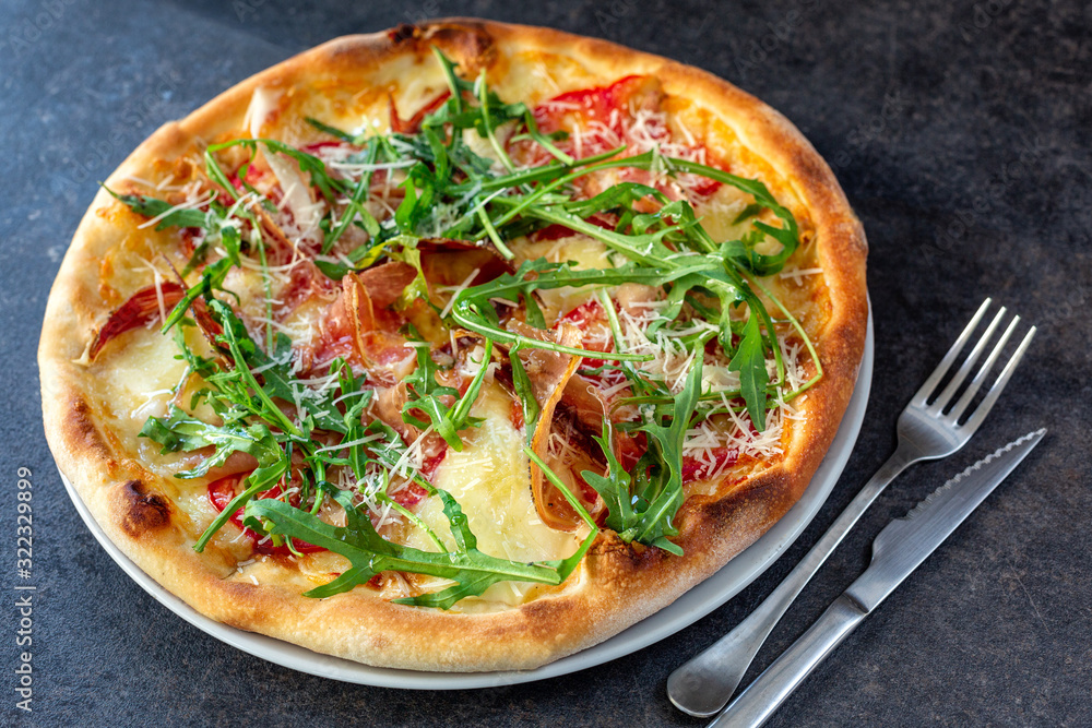 Tasty looking pizza with rocket plant toppings Tasty looking pizza with rocket plant toppings