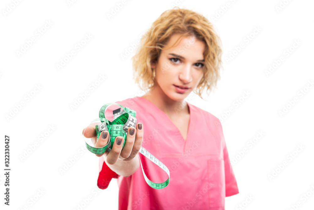 Selective focus of nurse wearing pink scrub holding measure tape Selective focus of nurse wearing pink scrub holding measure tape