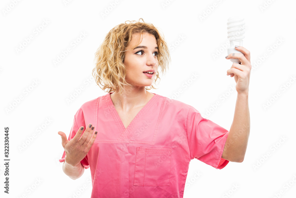 Portrait of nurse wearing pink scrub holding spiral light Portrait of nurse wearing pink scrub holding spiral light