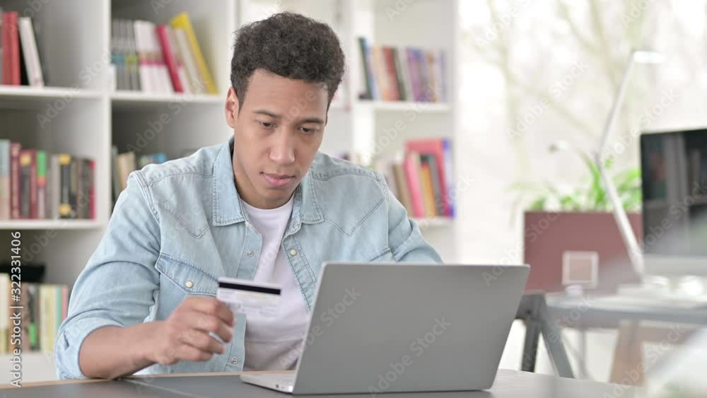 Online Shopping by Young African American Man, Using Credit Card for Payment Online Shopping by Young African American Man, Using Credit Card for Payment