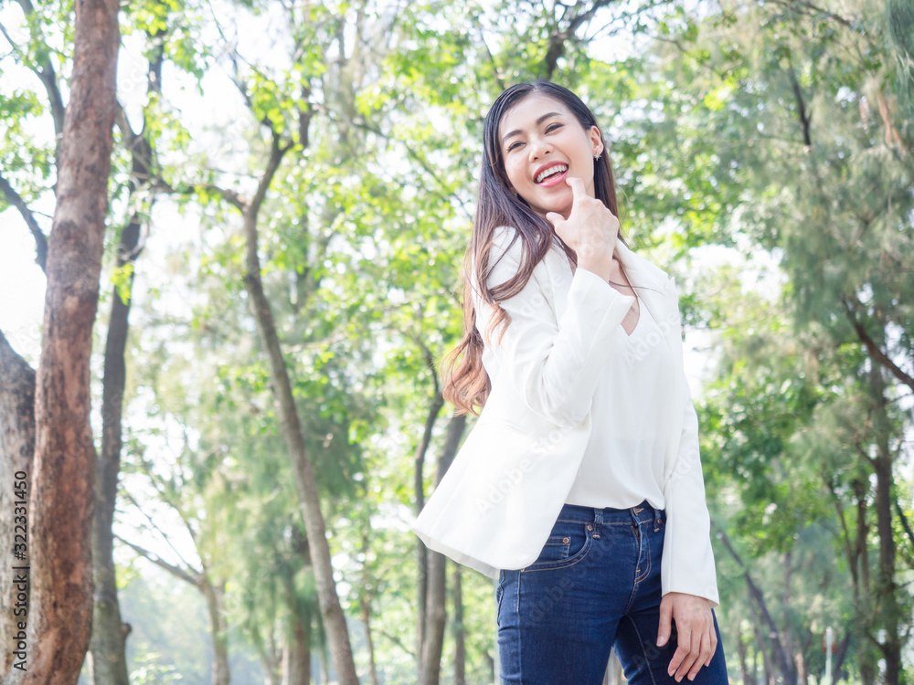 eautiful Attractive Asian Business woman smile face wearing white shirt stand in garden, park eautiful Attractive Asian Business woman smile face wearing white shirt stand in garden, park