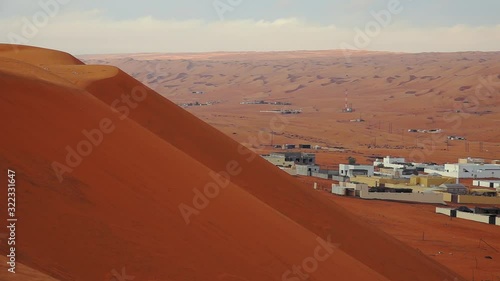 Town among Sandy Desert Dunes in Oman photo