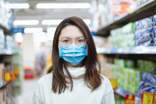 Asian woman wearing a mask in the supermarket