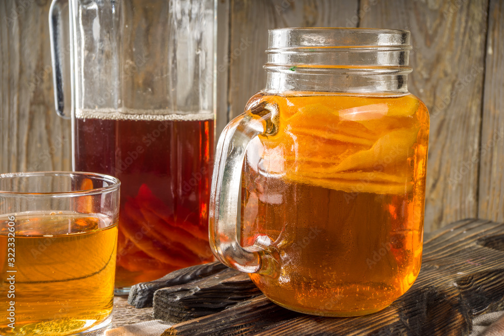 Fermented drink, Homemade sweet fermented tea Kombucha, in different jars and glasses Fermented drink, Homemade sweet fermented tea Kombucha, in different jars and glasses