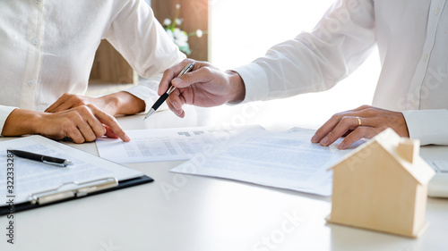 employee meeting broker estate agent for contact to apartment and signing document agreement.