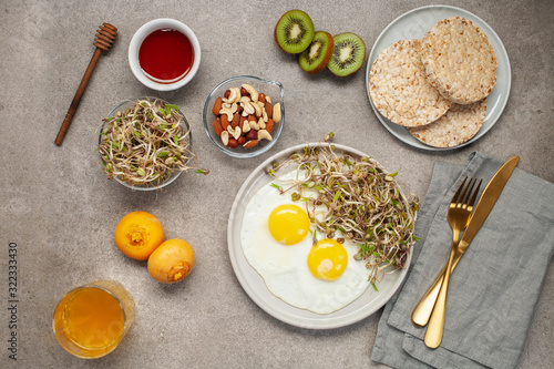 Healthy breakfast with egg, bean sprouts, fruit, honey and juice. Top view. Flat lay
