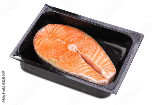 One fresh raw Norwegian salmon steak in a black plastic box