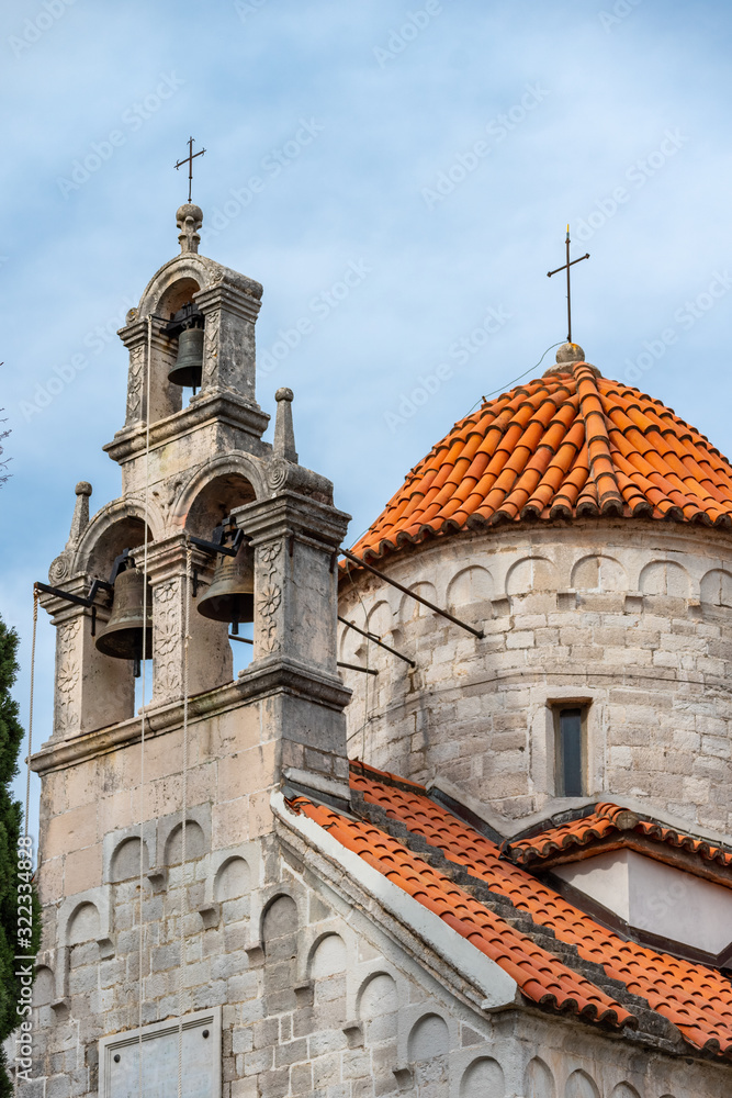 Herceg Novi / Montenegro - 05.02.2018: Ancient Byzantine-style church with a bell tower and a set of bells in the southern Adriatic.