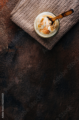 Vanilla custard with homemade cookie on wooden table. Top view. Copyspace