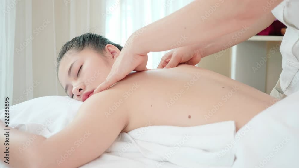Young Asian woman getting Relaxing oil massage at beauty spa salon. Back massage, Massage for health. Slow Motion Young Asian woman getting Relaxing oil massage at beauty spa salon. Back massage, Massage for health. Slow Motion