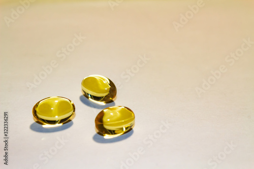 capsules of fish oil lie on a hand on a light background. view from above. vitamins for health.