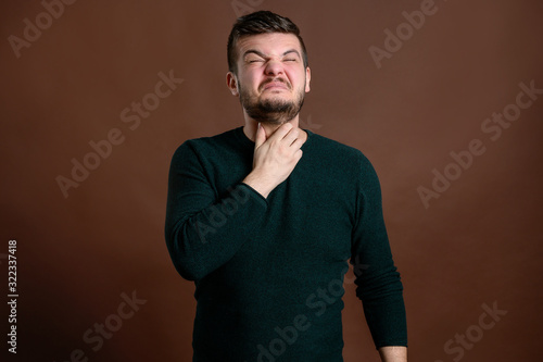 Young man with brown hair has sore throat photo