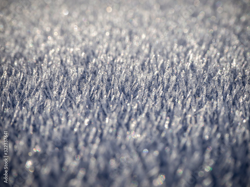 Close up macro abstract view of frost ice on the roof of a car in the early morning