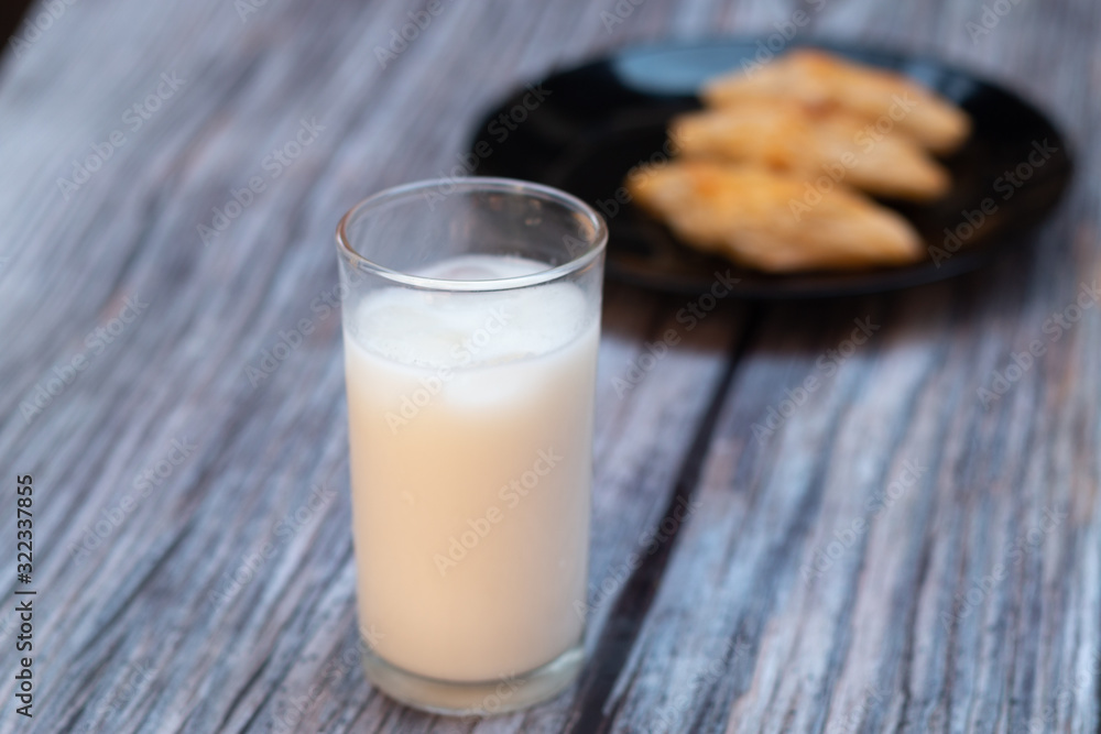 Ice milk with donut and bread on the wooden background. Ice milk with donut and bread on the wooden background.