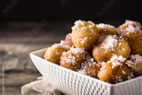 Carnival fritters or buñuelos de viento for holy week on wooden table photo