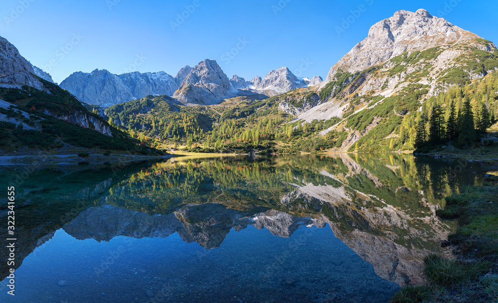 pictorial lake Seebensee in the morning, with reflecting mountains in the calm water, austrian landscape