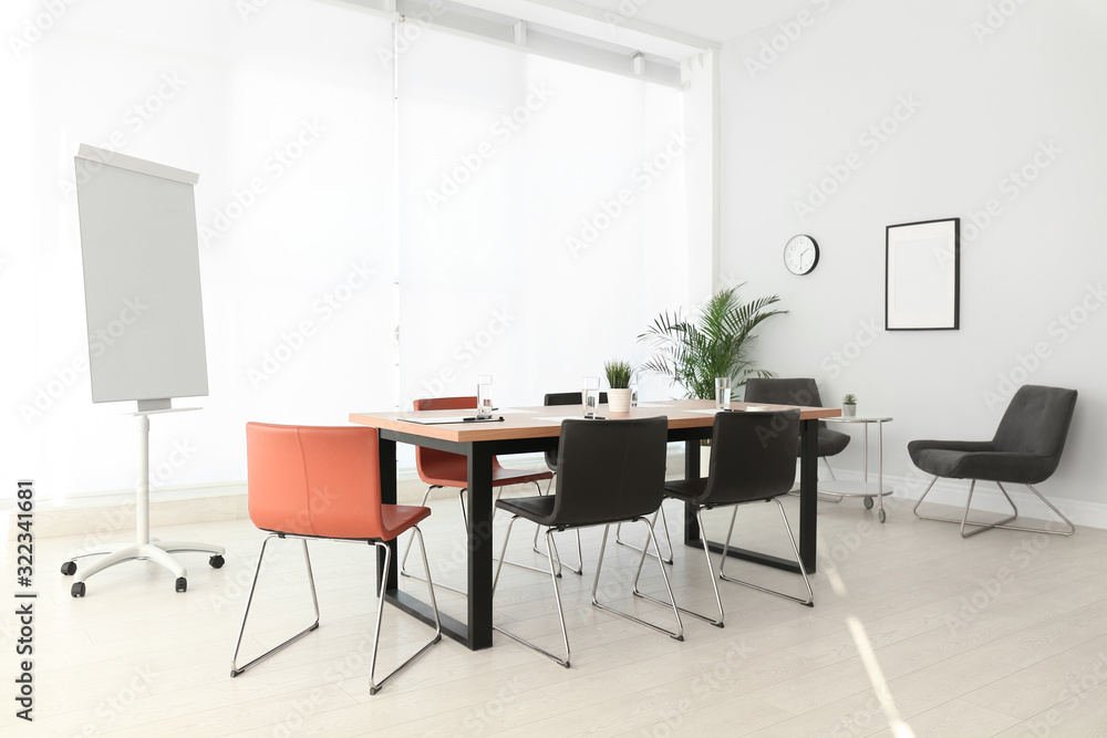 Simple office interior with large table and chairs