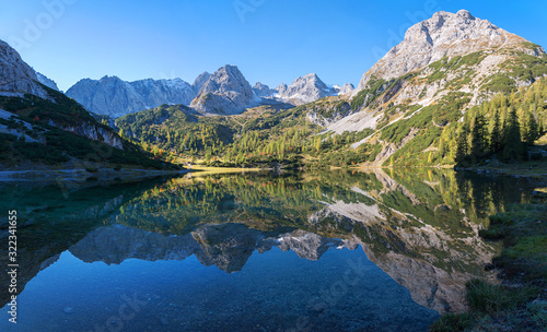 pictorial lake Seebensee in the morning, with reflecting mountains in the calm water, austrian landscape