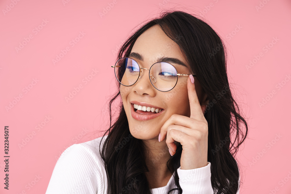 Image of young asian woman wearing eyeglasses smiling and looking aside Image of young asian woman wearing eyeglasses smiling and looking aside
