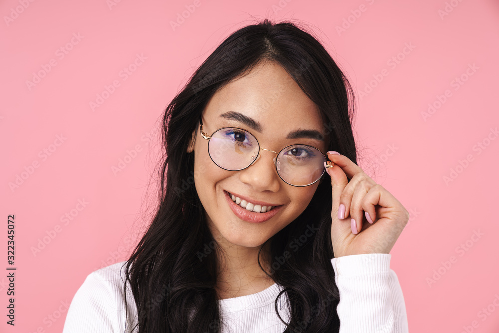 Image of young brunette asian woman wearing eyeglasses smiling at camera Image of young brunette asian woman wearing eyeglasses smiling at camera