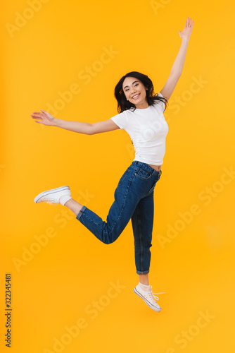 Full length image of young brunette asian woman smiling and having fun © Drobot Dean
