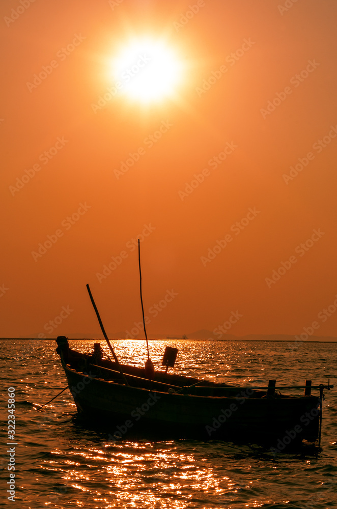 Silhouette of Small Wooden Boat Floating on the Sea