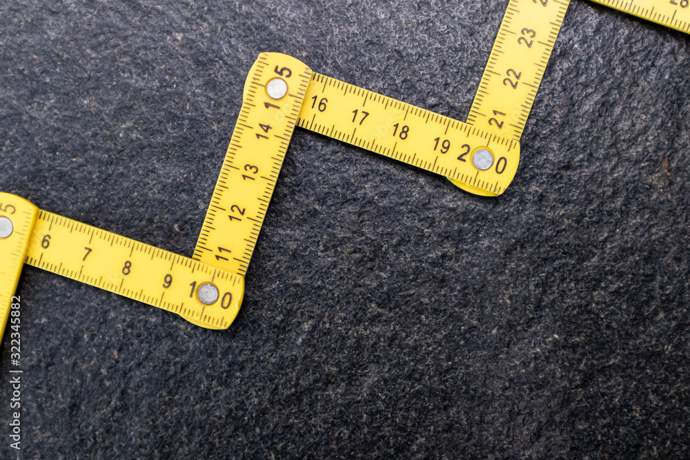 Folding zig zag ruler. Measuring tape folding yellow open in zigzag