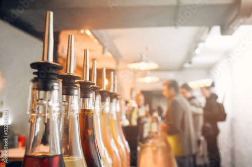 Φωτογραφία Glass bottles with dozers or dispensers for pouring alcohol cocktails, beverages