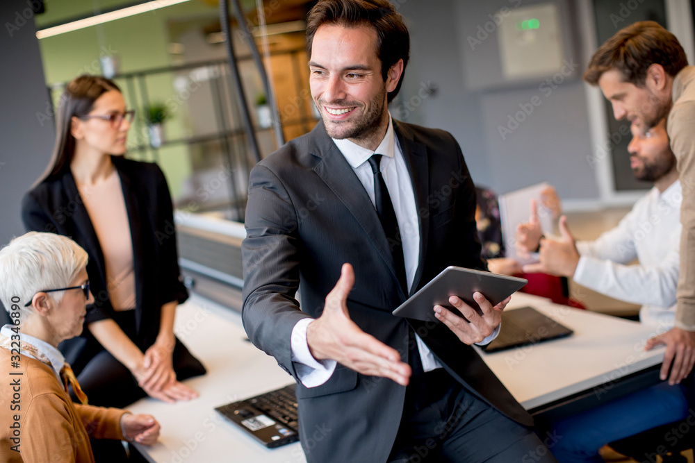 Young businessman using digital tablet in office Young businessman using digital tablet in office