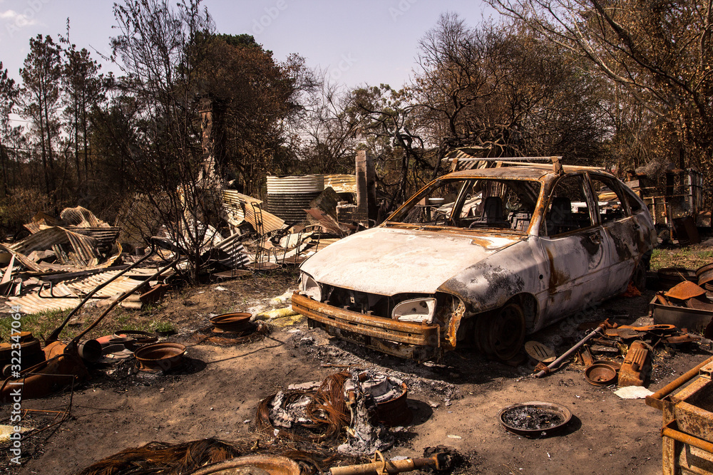 Building and car destroyed by fire. Bushfire aftermath, Australia Stock