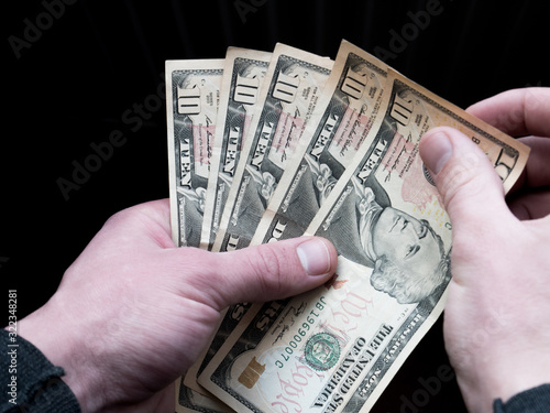 Dollars stack in hands. Man holding american dollars