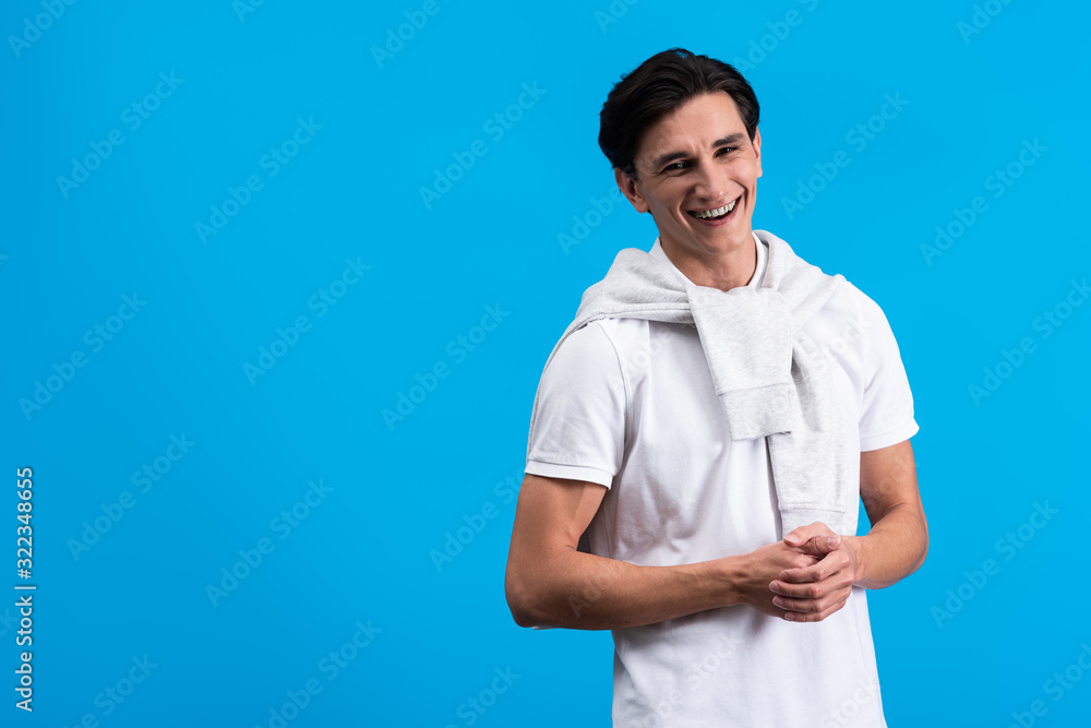 portrait of cheerful young man, isolated on blue portrait of cheerful young man, isolated on blue