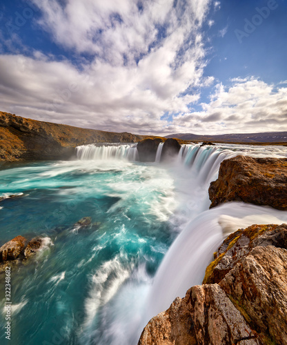 Fototapeta Naklejka Na Ścianę i Meble -  Panorama of most famous place of Golden Ring Of Iceland. Godafoss waterfall near Akureyri in the Icelandic highlands, Europe. Popular tourist attraction. Travelling concept background. Postcard.