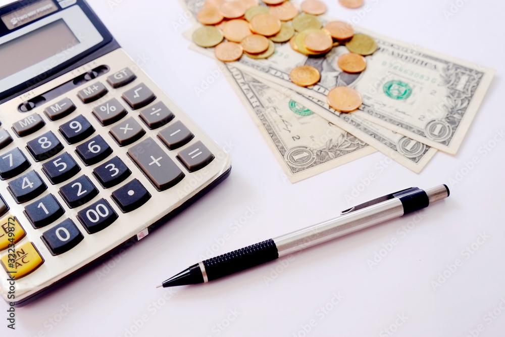 calculator,pen and money coins on isolated white background.business finance saving planning account concept. Trade market. Finance control. Credit concept. Calculate profit. calculator,pen and money coins on isolated white background.business finance saving planning account concept. Trade market. Finance control. Credit concept. Calculate profit.