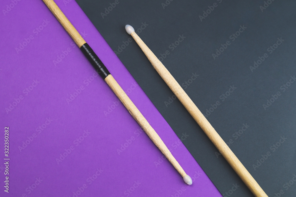 A pair of wooden drumsticks isolated on color background