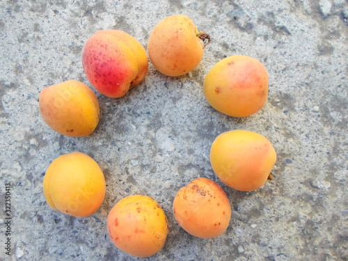 many apricots on a concrete wall. Closeup of fresh apricots as a background. place for text