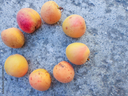 many apricots on a concrete wall. Closeup of fresh apricots as a background. place for text