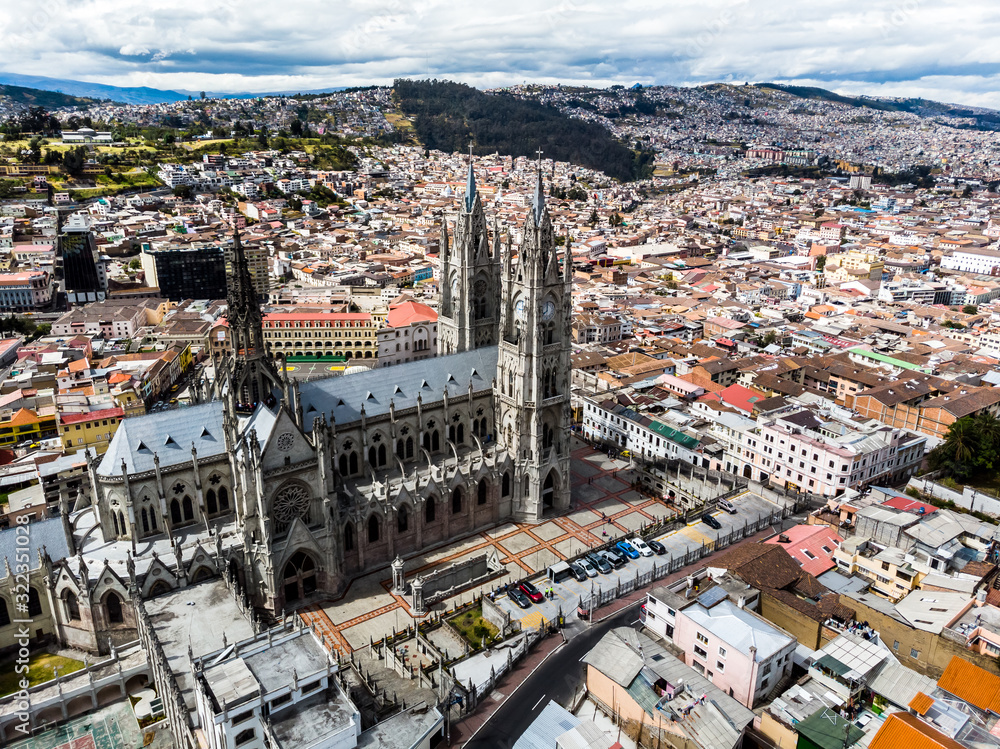 Fototapeta premium Aerial view of the Basilica of the National Vow, Panecillo and Colonial Quito