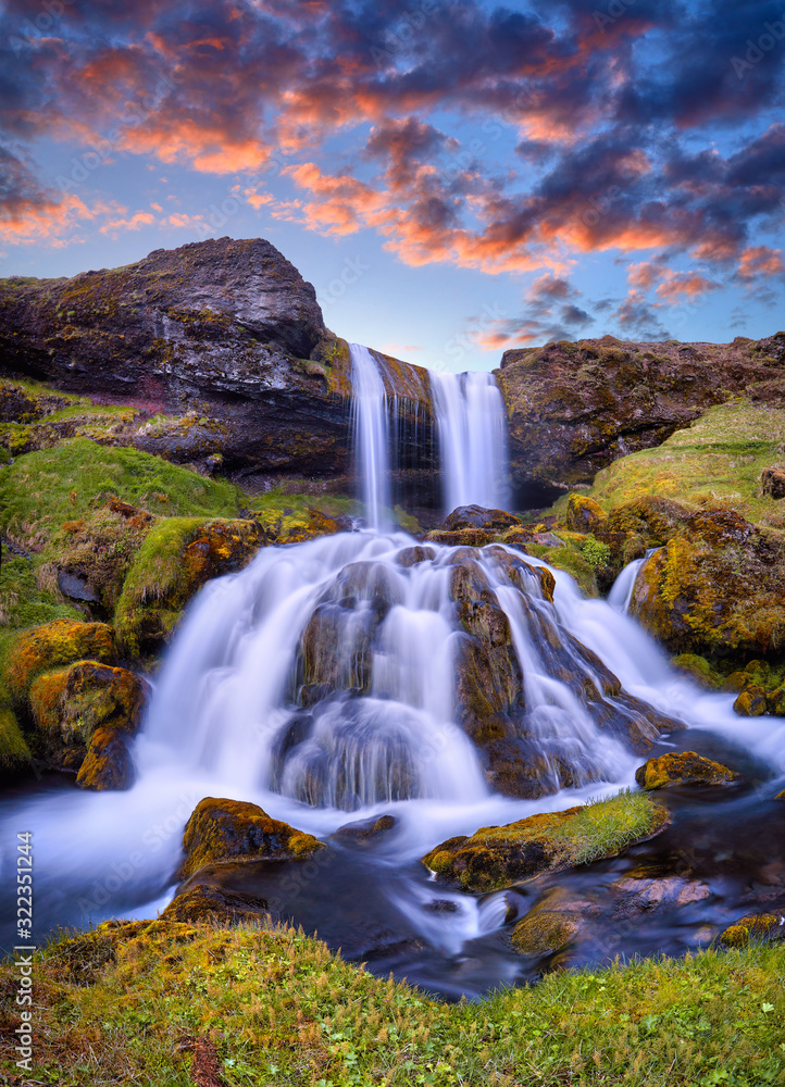 Sheep's Waterfall. Famous tourist landscape. Travel concept background. Dramatic summer sunrise, Iceland, Atlantic Ocean, Europe. Travel postcard.