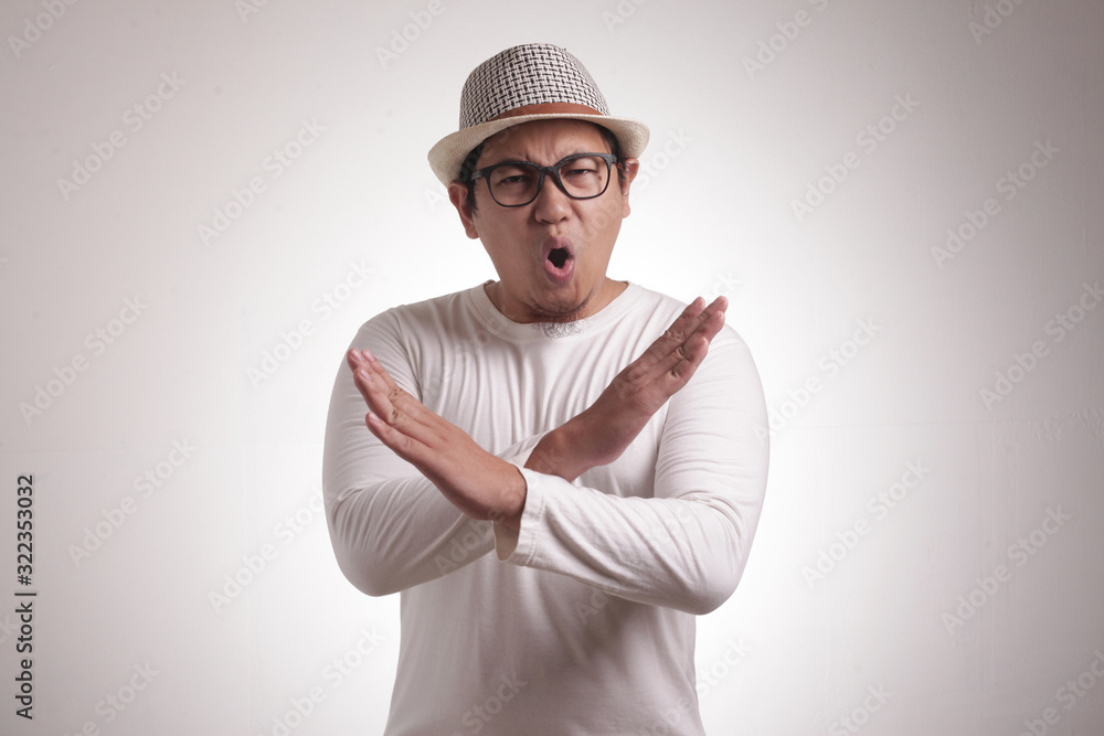 Angry Young Man Shows Stop Sign Crossed Arms gesture Angry Young Man Shows Stop Sign Crossed Arms gesture