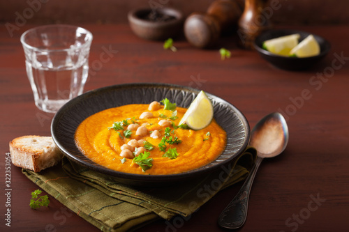 creamy carrot chickpea soup on dark rustic background