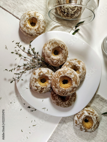 Iced homemade gingerbreads on a white plate in light pastel tones