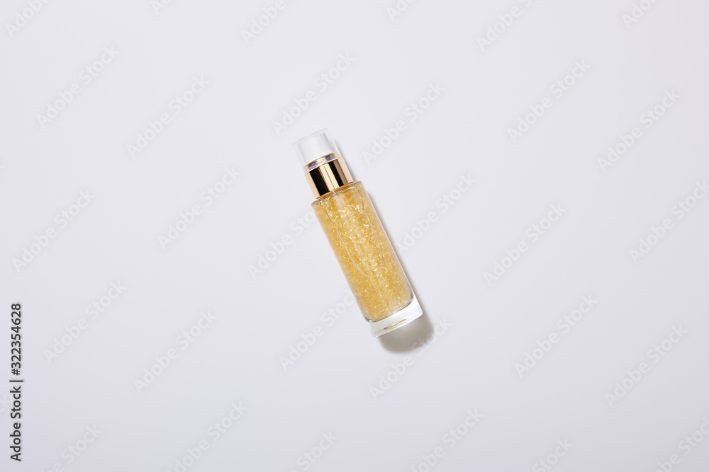 Top view of bottle of cosmetic oil on grey background Top view of bottle of cosmetic oil on grey background