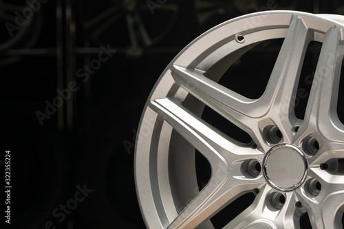alloy wheel silver, rim new car wheel on a black background close up. Copyspace copy space, front view