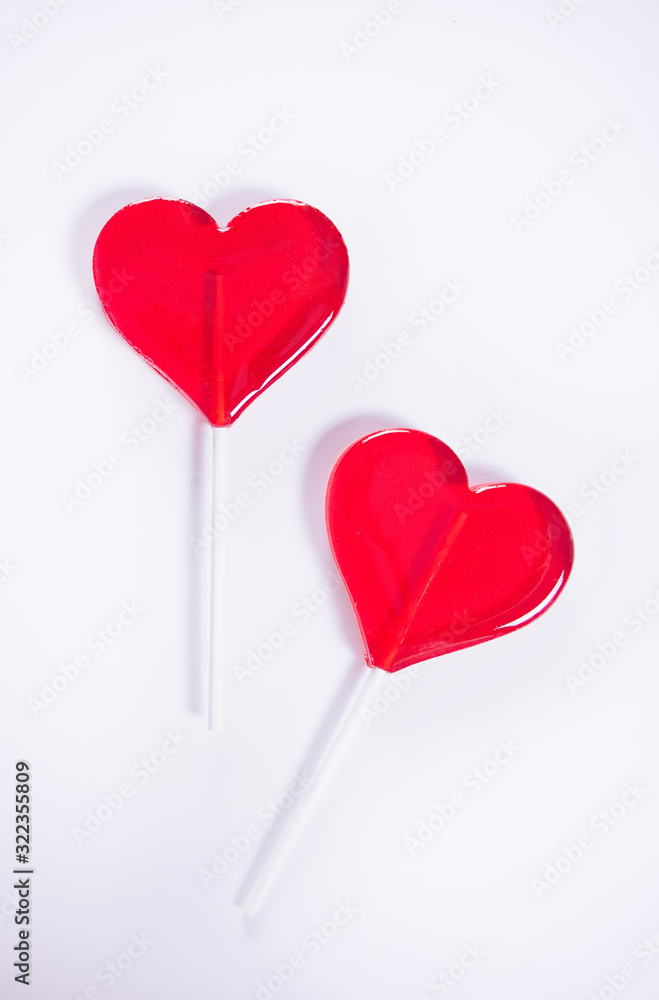 Two red heart shaped lollipops candy for Valentines day. Top view. Copy space.