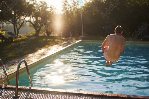 Man jumping into swimming pool 