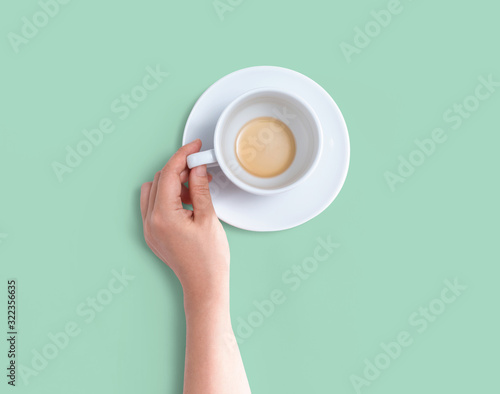 Female hand holding a tea cup overhead view - flat lay