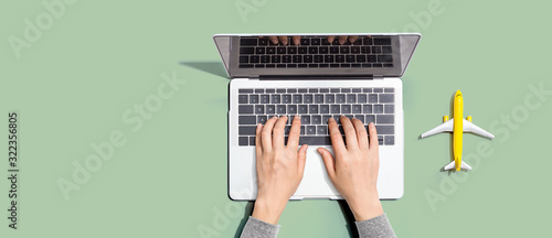 Fotografie Flights online booking and reservation theme with person using a laptop computer